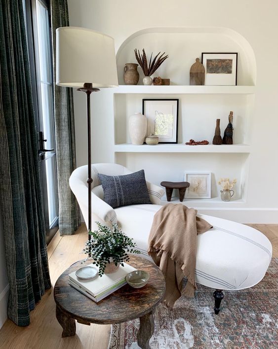 a chic living room with an arched niche with beautiful decor and vases is a gorgeous and chic space with its own style
