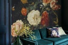 07 a moody living room with a realistic flower wall mural, a dark green sofa and lanterns is a chic and bold space