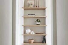 12 a large arched niche with wooden shelves for displaying stuff is a cool solution for an awkward nook