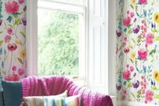 21 colorful floral print wallpaper in the living room and a matching knit fuchsia blanket