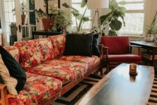 24 a mid-century modern lviing room with a black and white rug, a floral sofa, rust-colored chairs, potted plants and a floor lamp