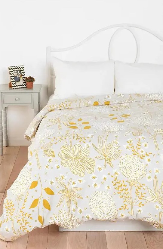 a pretty yellow floral and botanical print blanket is all you need to refresh the space for spring
