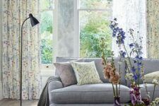 34 a light and airy spring living room with a grey sofa, floral curtains and fresh blooms in colorful vases is very cool