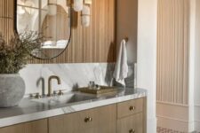 35 a contemporary bathroom with an arched niche clad with wood, a curved mirror, a floating vanity and cool pendant lamps