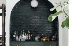 47 an arched niche clad with dark green brick, with a lamp and a some bar done with green cabinets is a fantastic idea
