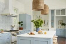 a lovely coastal kitchen design with blue cabinets