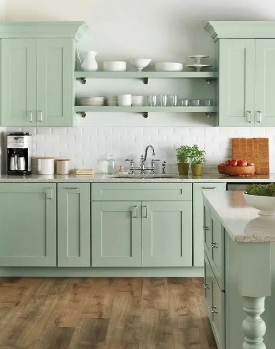 a beautiful farmhouse kitchen in mint green, with shaker cabinets, open shelves, white subway tiles and vintage fixtures