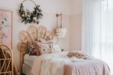 a boho chic bedroom with blush color block walls, pink bedding and rattan furniture is very glam