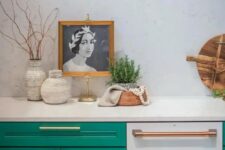 a bold emerald kitchen with shaker cabinets, a white quartz backsplash and matching countertops, some lovely decor