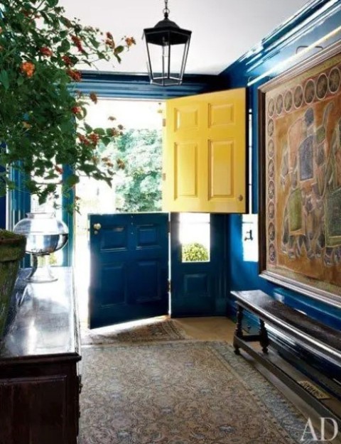 a bold entryway with a bright blue and yellow Dutch door that makes a colorful statement