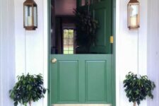 a lovely entrance with a colorful front door framed with planters