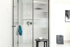 a contemporary shower space with framed fluted glass doors that give it an edgy and cool feel separating the shower and the bathroom