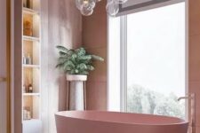 a cool bathroom with pink plywood walls, a pink tub, lit up built-in shelves and lots of bubble lights over the bathtub