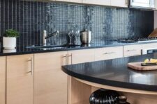 a creative stained kitchen with a glossy black tile backsplash and black countertops look very fresh and contrasting