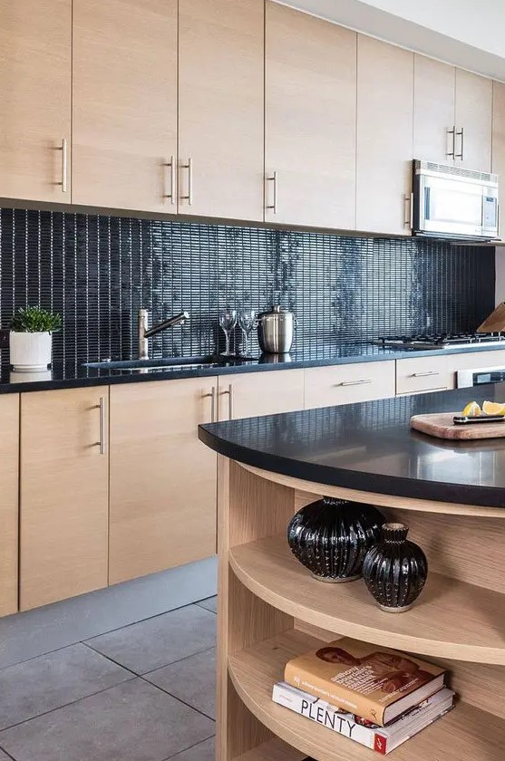 a creative stained kitchen with a glossy black tile backsplash and black countertops look very fresh and contrasting