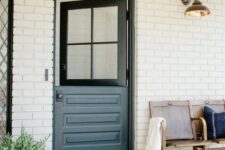 a farmhouse entrance with a bench, a graphite grey Dutch door and a jute rug plus greenery in a basket is very welcoming