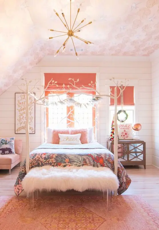 a fun bedroom with a light pink ceiling, a bright pink rug, a pink chair, pillow and coral Roman shades for a touch of color