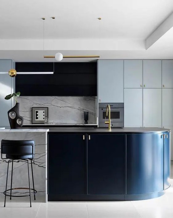a light blue kitchen with a black hood, a curved black and white kitchen island, a white marble backsplash and countertops