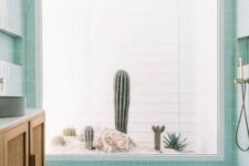 a lovely aqua bathroom with a shower that has a cacti view, a rattan vanity and concrete sinks is super cool