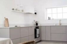 a minimalist grey kitchen with white countertops, open shelves, a white hood, pendant bulbs is a lovely idea