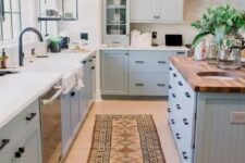 a lovely kitchen with a butcher block countertop on a kitchen island