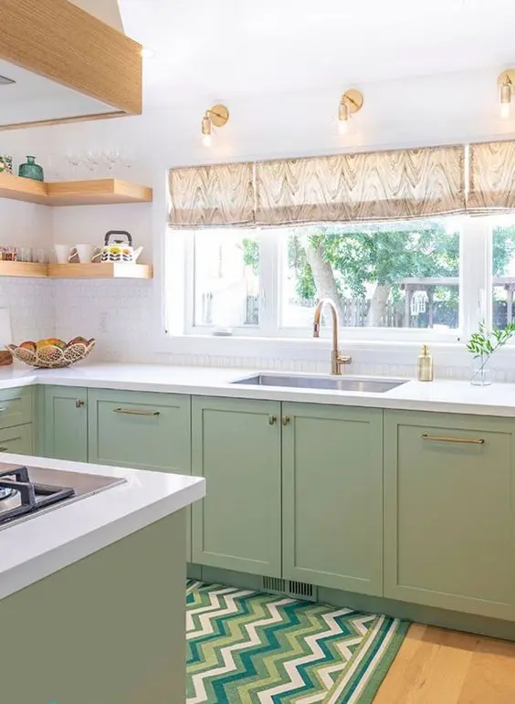a modern farmhouse kitchen with shaker cabinets, white stone countertops, open corner shelves and gold and brass fixtures
