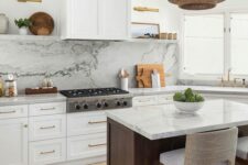 a modern farmhouse kitchen with white shaker cabinets, a white quartz backsplash and countertops, a stained kitchen island, a woven pendant lamp