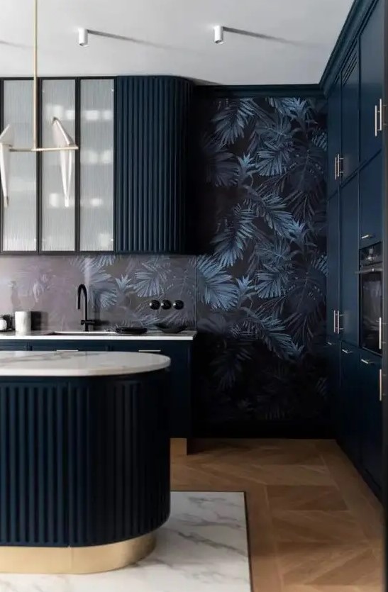 a moody and elegant kitchen with midnight blue curved cabinets and a matching kitchen island, dark wallpaper on the walls and black fixtures