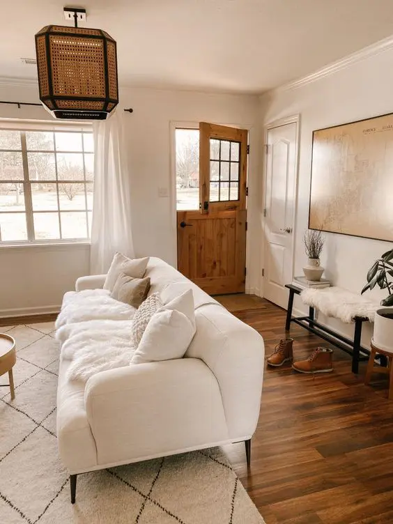 a neutral farmhouse interior with a stained Dutch door that perfectly matches the style and adds coziness to the space