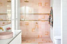 a pastel pink and white bathroom with a shower space with a niche, a floating white vanity, a pink sink and a large mirror