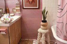 a lovely bathroom with a pink bathtub