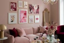 a refined pink living room with a low pink sofa and an ottoman, catchy coffee tables, a burgundy chair and a pink and burgundy gallery wall