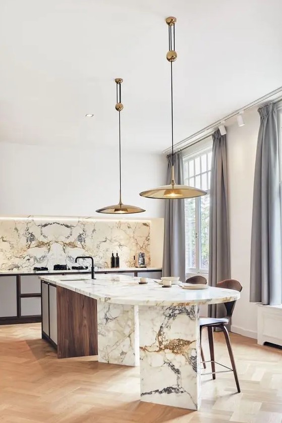 a sophisticated contemporary kitchen with sleek white cabinets, a curved kitchen island made of wood and marble