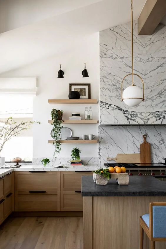 a sophisticated stained kitchen with shaker cabinets, white marble and black granite countertops and a white marble backsplash
