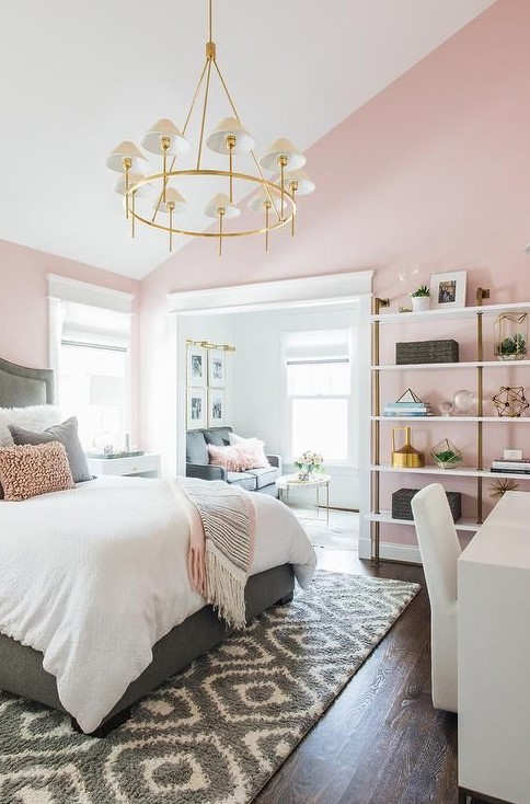 a stylish mid-century modern bedroom with light pink walls and grey, white and gold everything is very elegant