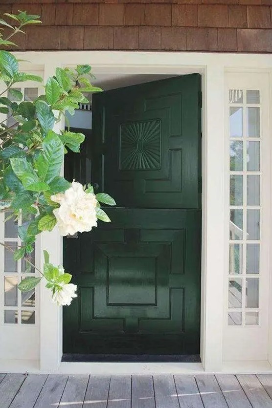a stylish modern entrance with French windows and a cool patterned black Dutch door plus greenery around