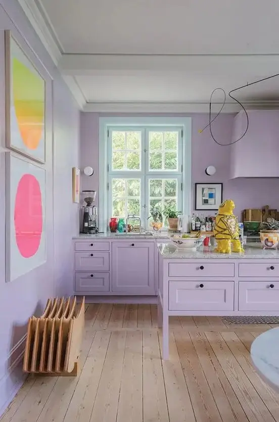 a tender lilac kitchen with bright abstract artworks is a very girlish and welcoming space