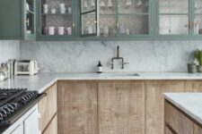 an eye-catchy kitchen with textural wood and green glass front cabinets, white stone countertops and a backsplash