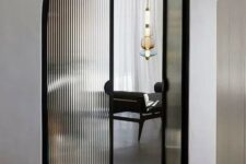 beautiful black frame arched fluted glass doors will instantly elevate the space to a new level and will highlight its refined look