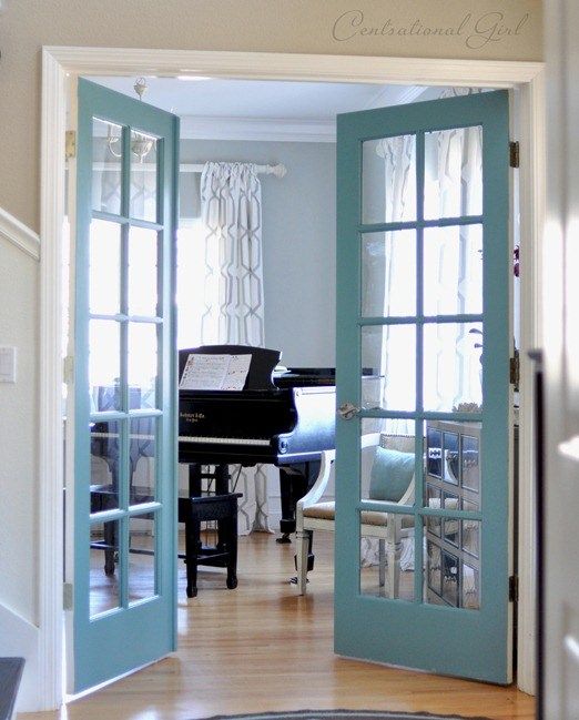 blue French doors add color to the space and make entrance to the music room more beautiful and chic