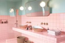 bright pink tiles paired with light blues, with gold fixtures and black grout for a bold look