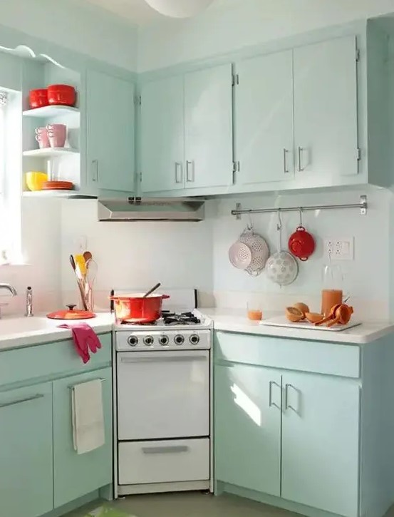 mint colored cabinets and some bold tableware are all you need to create a retro feel in the kitchen