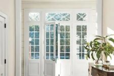 such white French doors with panes are wonderful for any space and perfectly fit this modern and elegant room