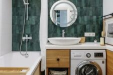 18 a bright and cool bathroom with a green skinny tile wall, a tub, a timber vanity with a built-in washine machine