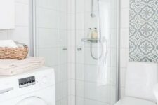 32 a small and lovely neutral bathroom with printed and white squre tiles, a white toilet and a washing machine is airy and cool