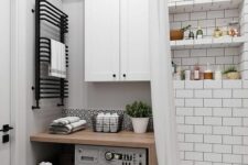 42 a tiny neutral bathroom clad with subway tiles, with a tub, a built-in washing machine, some storage cabinets and a sink shows how to effectively use the space