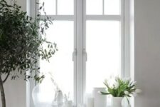 a Scandinavian space in white, with a casement window and a bit of paning for a cute touch is chic