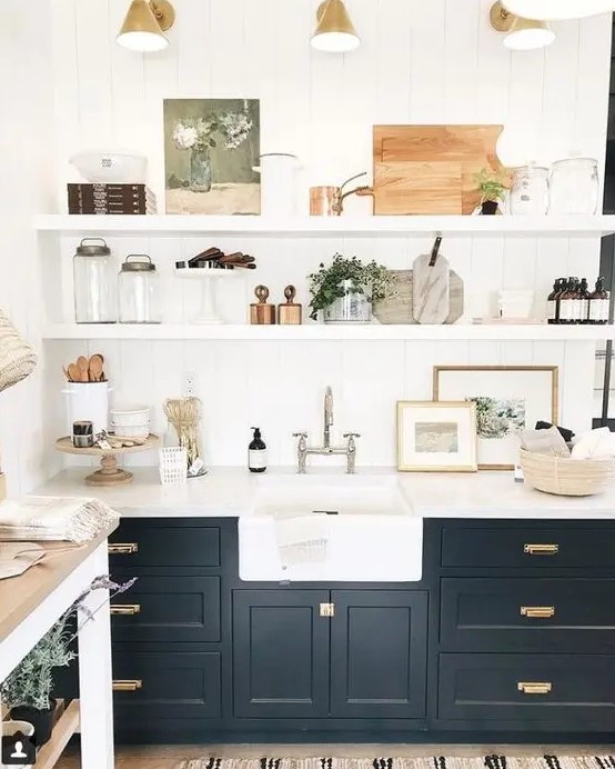 a beautiful black farmhouse kitchen with shaker cabinets, floating shelves, retro sconces and mixed metals for more eye catchiness