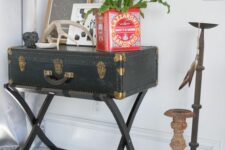 a black vintage chest on framed legs as a console table, a potted plant and some artwork is a great idea for any space