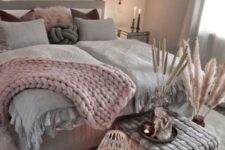 a stylish nordic bedroom with grey and pink tones